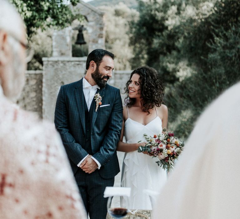 Bride in Max Mara wedding dress with groom at ceremony