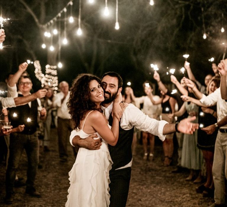 Sparkler exit for bride in Max Mara wedding dress and groom