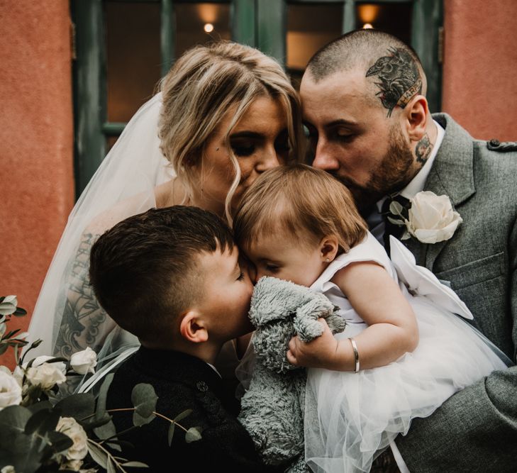 Bride, Groom and Their Children Embracing