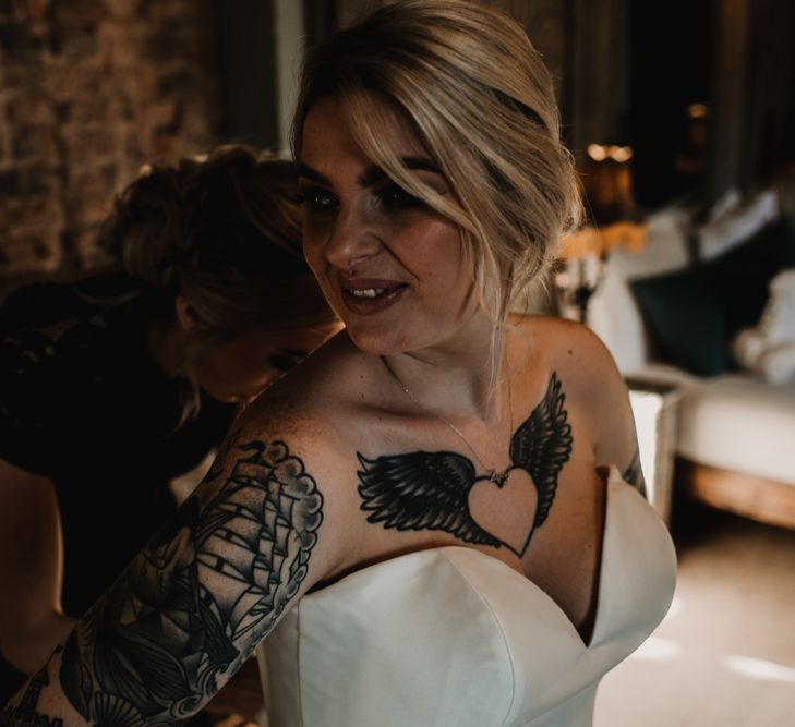 Bride in Sweetheart Neckline Wedding Dress Showing Off Her Heart and Wings  Tattoo