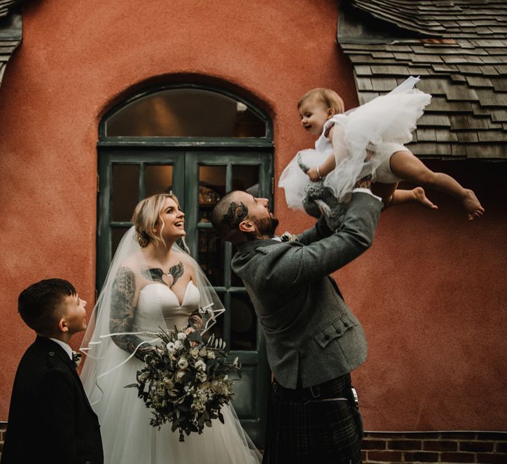 Family Portrait with Tattooed Bride in Essense of Australia Wedding Dress and Groom in Kilt