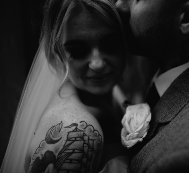 Black and White Portrait of Groom Kissing His Bride