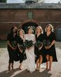 Bride and bridesmaids all holding preserved flower bouquets.