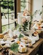 Vegan wedding inspiration with a dessert table and white iced wedding cake.