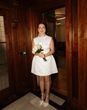Bride wearing budget-friendly Odd Muse short wedding dress for city town hall wedding