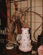 Light pink retro three tier wedding cake with cherries decorations to top