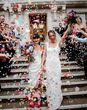 Colourful confetti exit on steps at town hall wedding