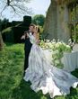 White spring wedding dress with train and pink floral pattern