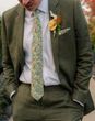 Groom wearing green floral patterned wedding tie 
