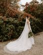 Bride in autumn wedding dress in autumn garden