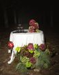 Burgundy and green colour trend wedding flowers on oval table