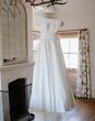 Off the shoulder wedding dress on personalised white hanger