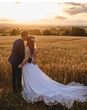 Dewsall Court sustainable wedding venue, couple embracing in a field on their wedding day