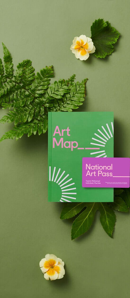 National Art Pass with Art Map booklet displayed on a green background with flowers and leaves, ideal as a unique wedding gift idea