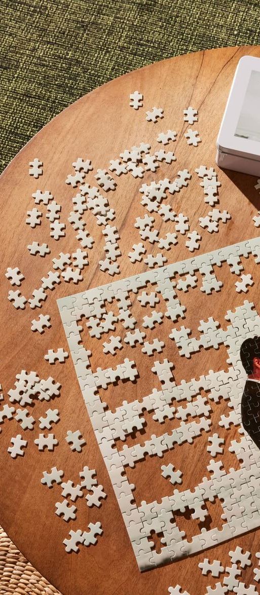 Personalised wedding photo custom jigsaw puzzle from VistaPrint showing a couple on their wedding day being assembled on a wooden table.
