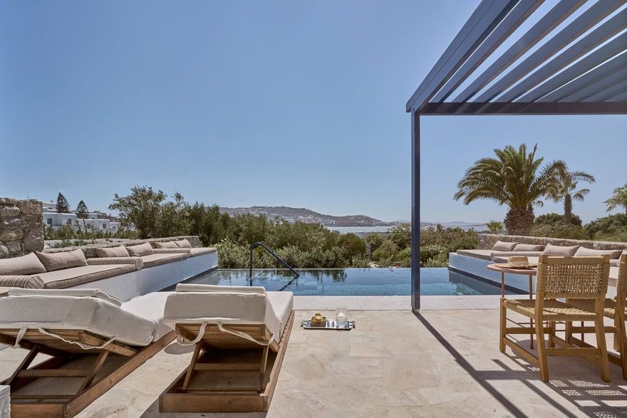 Private terrace at Mykonos Theoxenia Hotel suite with infinity pool and views over the Aegean landscape