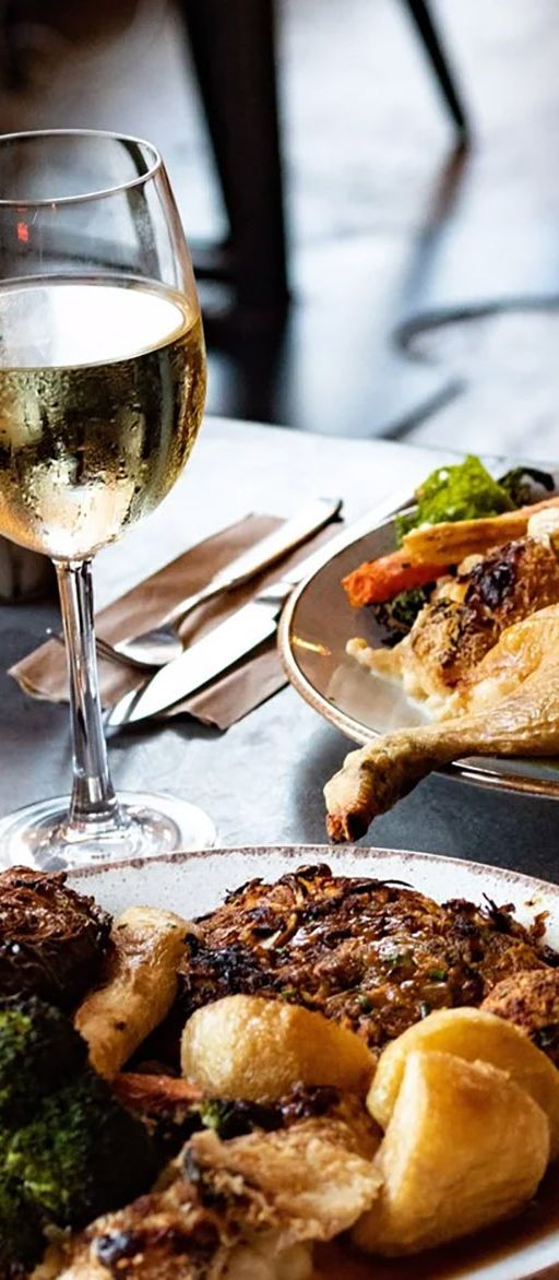 Plates of food, wine and cocktails at the Elnecot bottomless brunch in Manchester