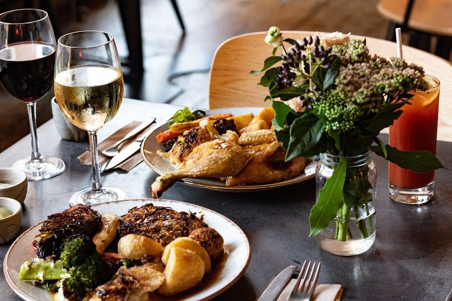 Plates of food, wine and cocktails at the Elnecot bottomless brunch in Manchester