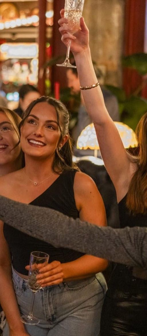 Group of five girls with prosecco at the Flight Club bottomless brunch 