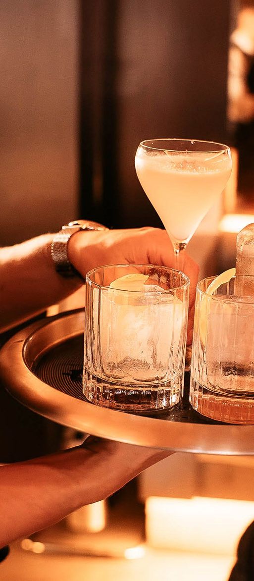 Waiter holding a tray of cocktails at the Maya Manchester bottomless brunch