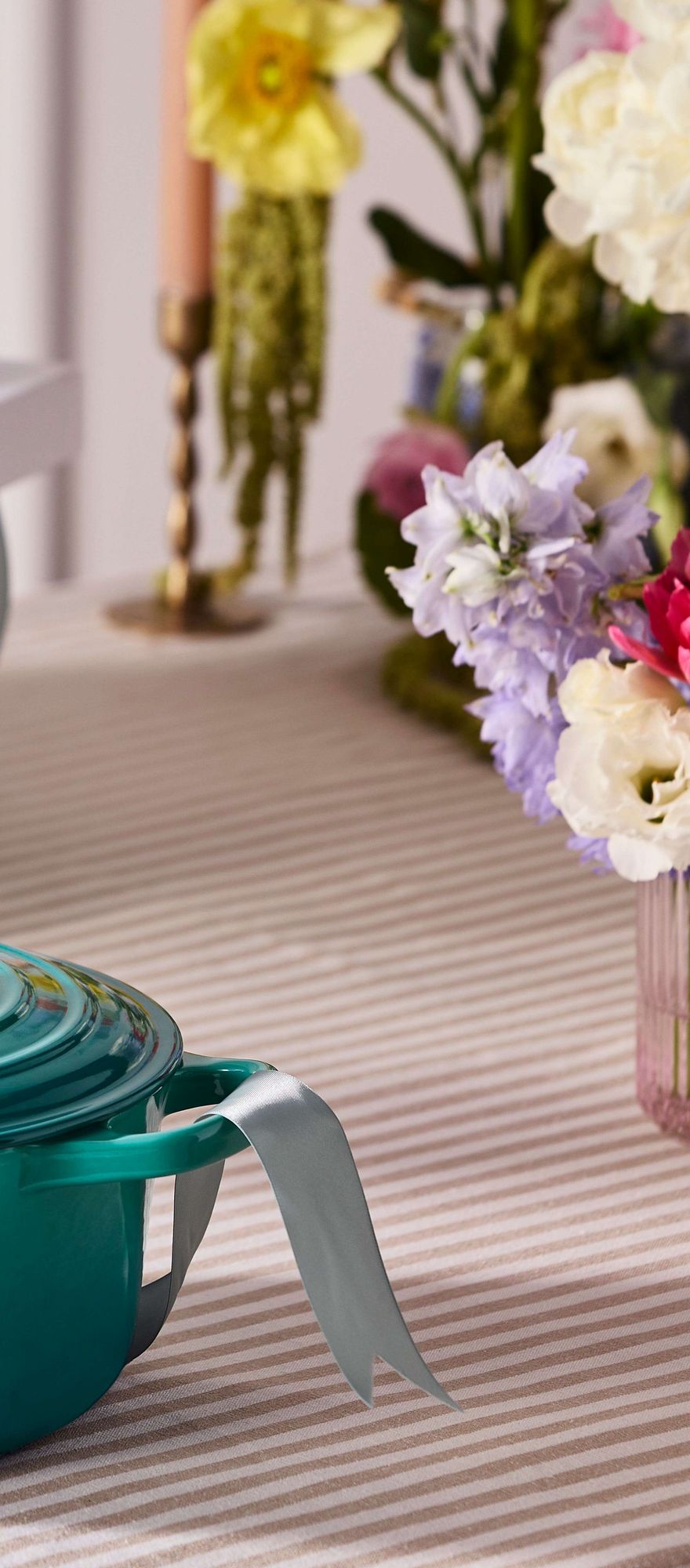 Le Creuset Bleu Riviera cast iron casserole dish styled as a luxury wedding gift alongside pastel florals and elegant table decor