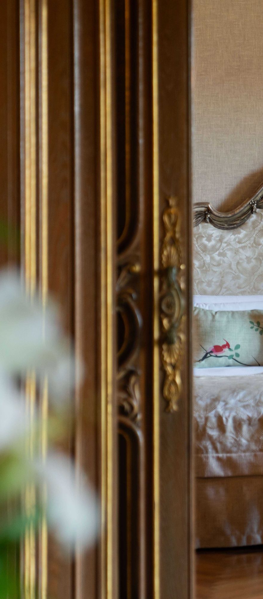 Luxury bedroom inside the Royal Suite at Hostal de La Gavina, featuring ornate wood panelling, antique furnishings and classic European design.