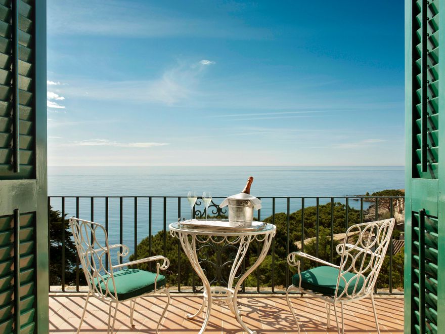 Private terrace with champagne and panoramic sea views at Hostal de La Gavina on the Costa Brava.