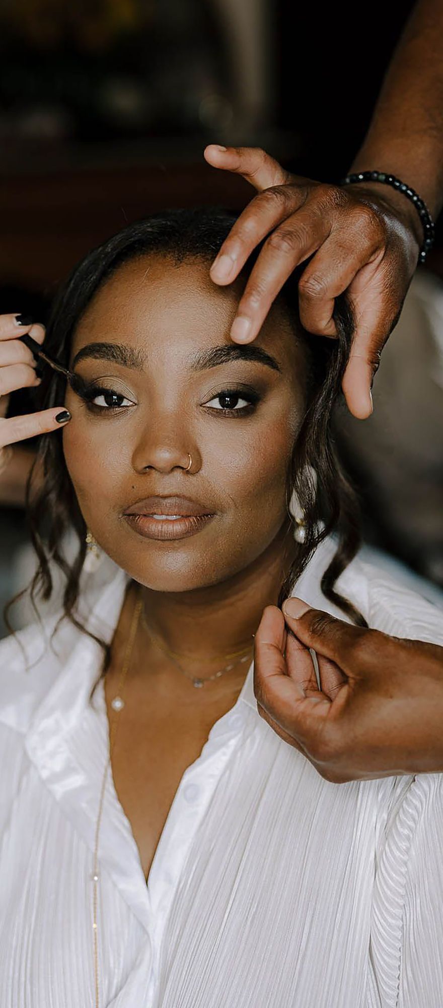 Bride having her hair and make up done with glowing skin