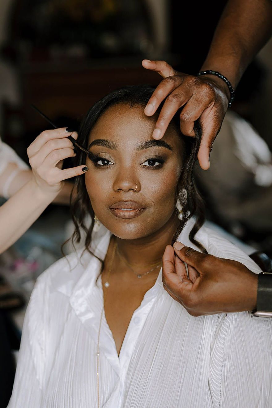 Bride having her hair and make up done with glowing skin