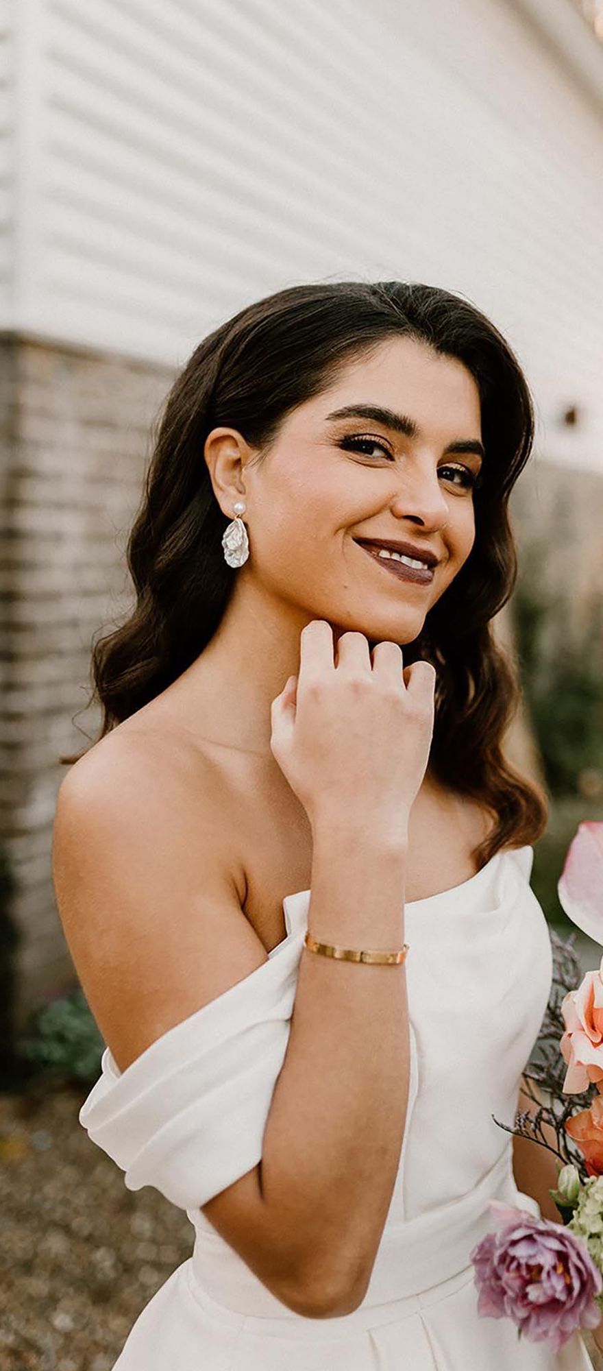 Bride with dark lipstick and gold eyeshadow with glowy skin