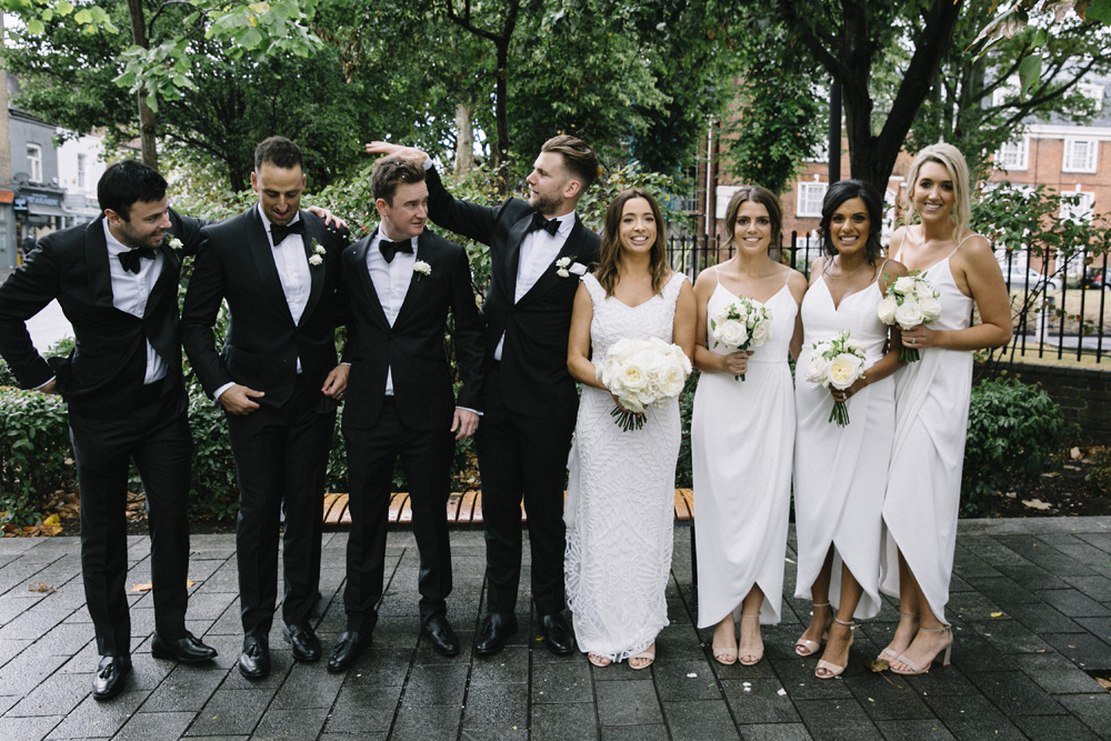 White Bridesmaids Dresses And Black Tuxedos For Sophisticated